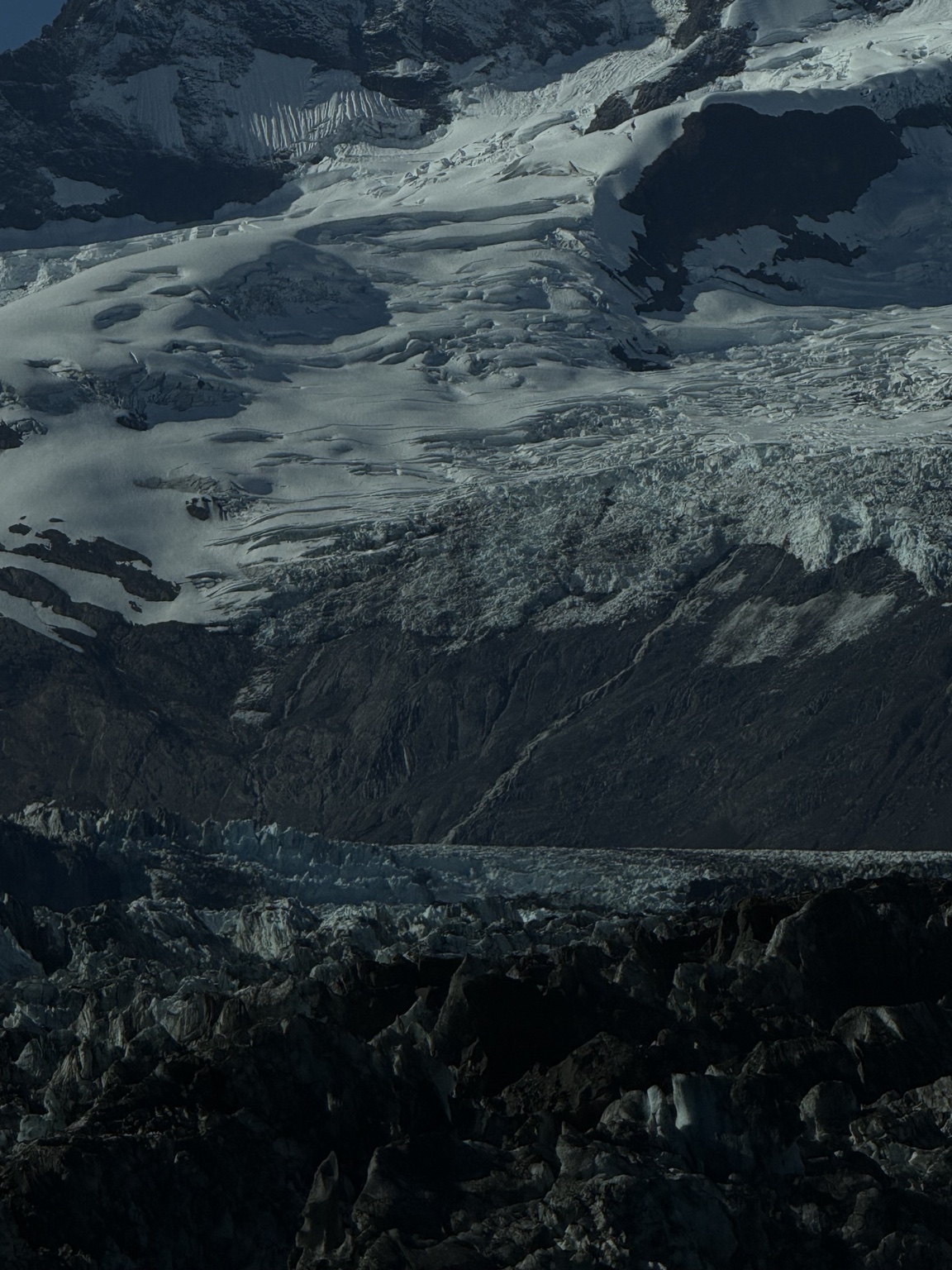 Close view of rugged glacier ice and mountain rock