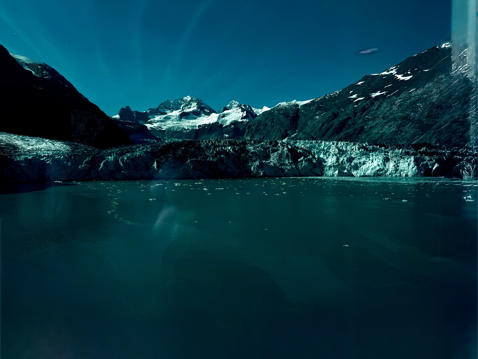 Wide Alaska glacier meeting cold blue water